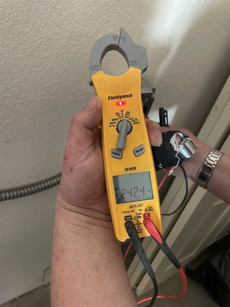 Voltage testing with clamp meter during Ceiling Fan Installation in New London